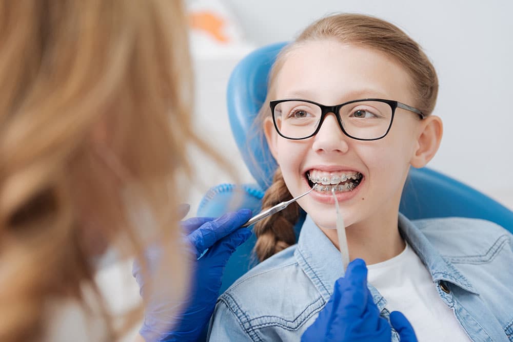 Doctor looking at child's braces